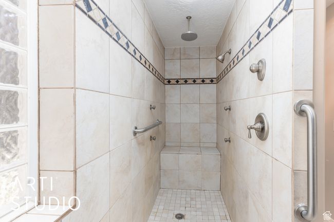Full bath with a tile shower and a textured ceiling | Image 27