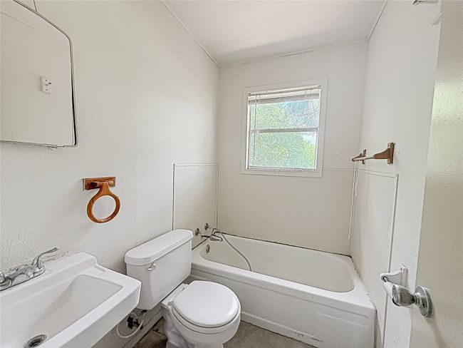 Bathroom featuring toilet and a sink | Image 13