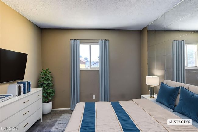 Bedroom featuring dark carpet and a textured ceiling | Image 6