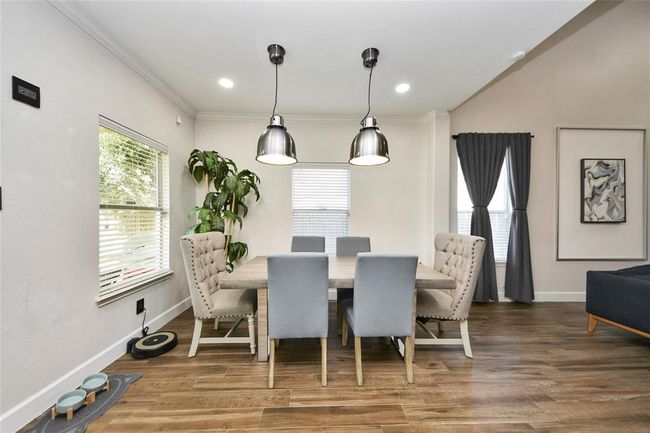Bright and inviting dining area featuring stylish pendant lighting. | Image 9