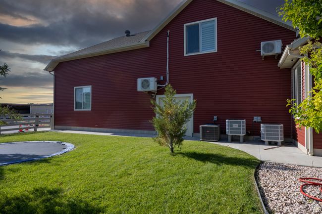 View of property exterior with central AC, a trampoline, and a cooling unit | Image 66