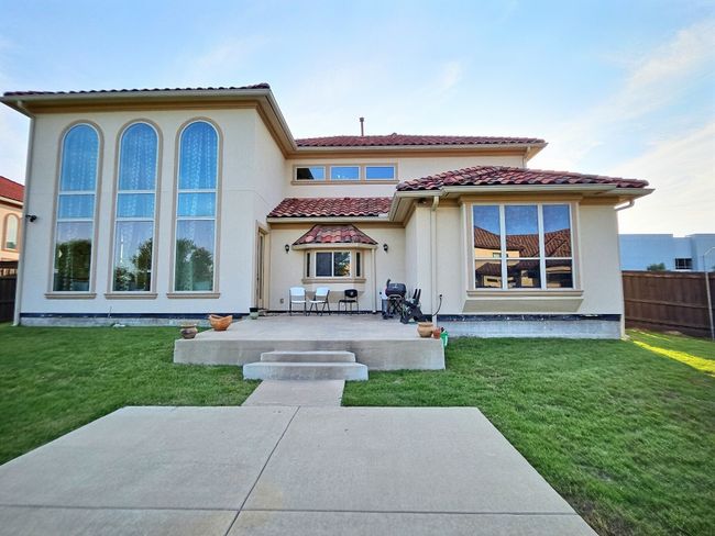 Rear view of property with a tiled roof, a patio area, and stucco siding | Image 36