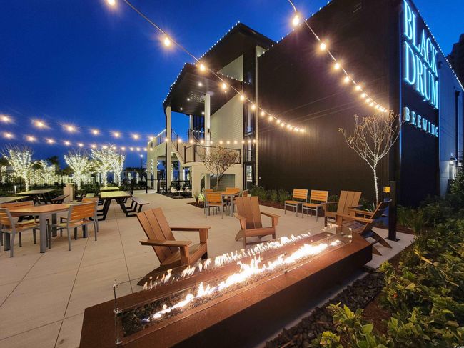Patio at night with an outdoor fire pit, outdoor dining area, and a patio | Image 40