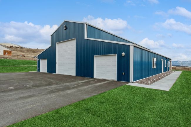 View of outbuilding featuring a mountain view, a yard, and a garage | Image 6