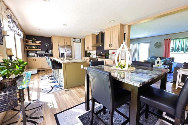 Dining area with a textured ceiling and wood finished floors | Image 7
