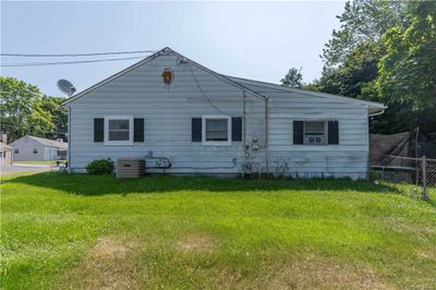 Back of property with a lawn and cooling unit | Image 2