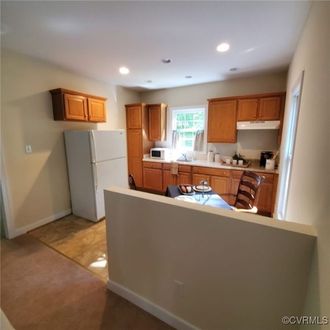 Kitchen with white appliances, recessed lighting, baseboards, and under cabinet range hood | Image 21