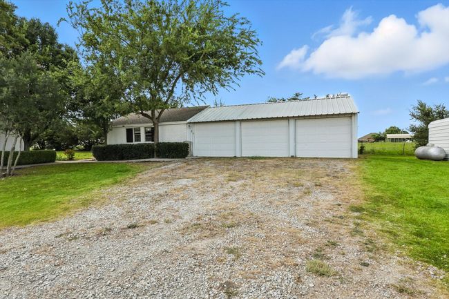 View of front of house featuring driveway, a front lawn, and a garage | Image 37