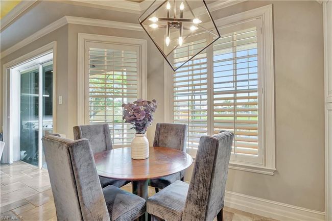 Dining area with crown molding, a chandelier, and baseboards | Image 20