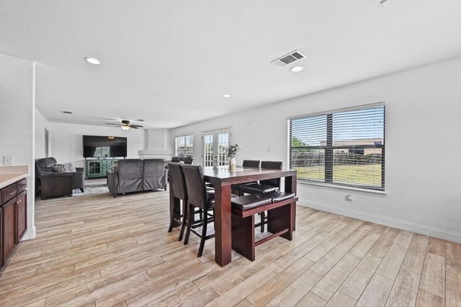 Dining area featuring light wood-style floors, ceiling fan, french doors, baseboards, and recessed lighting | Image 17