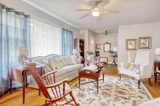 Living area featuring plenty of natural light, wood finished floors, and ceiling fan | Image 14