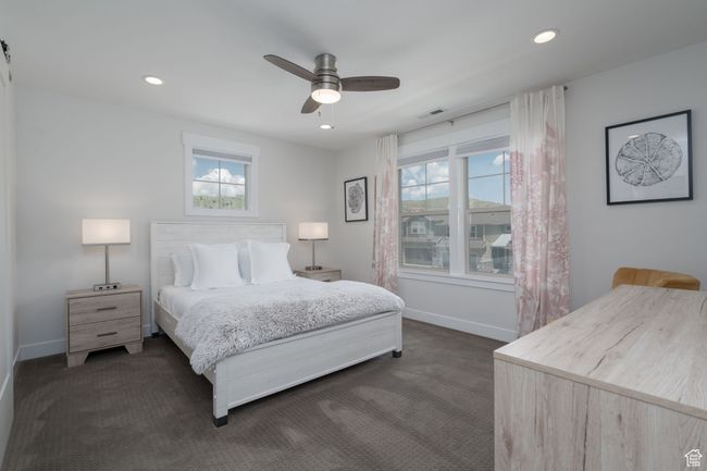 Bedroom with dark colored carpet, baseboards, recessed lighting, and ceiling fan | Image 27
