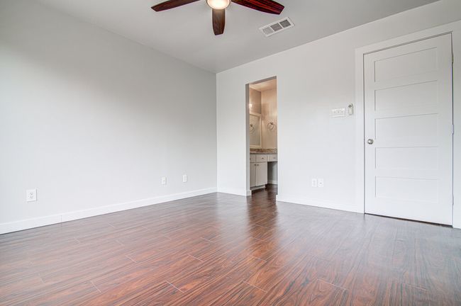Unfurnished room featuring dark wood-style flooring, visible vents, baseboards, and ceiling​​‌​​​​‌​​‌‌​‌‌​​​‌‌​​‌‌​‌​​​​​‌ fan | Image 16