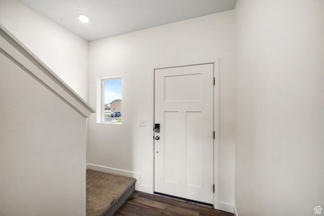 Foyer entrance featuring dark wood-style flooring and baseboards | Image 7
