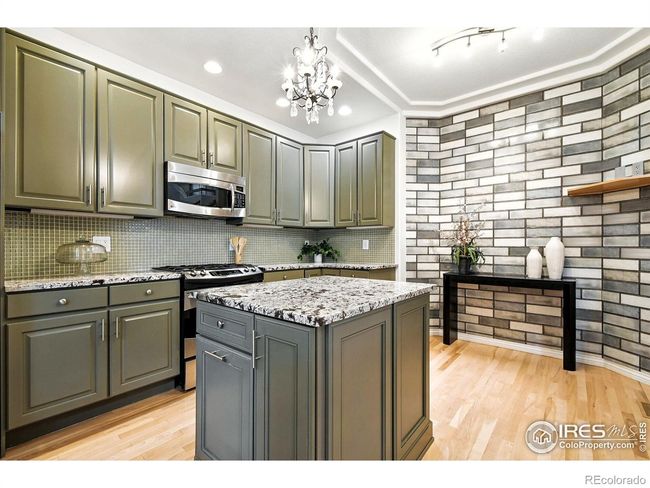 Lots of space on the granite countertops and island. A small table could fit against the back wall for an eat-in kitchen. | Image 5