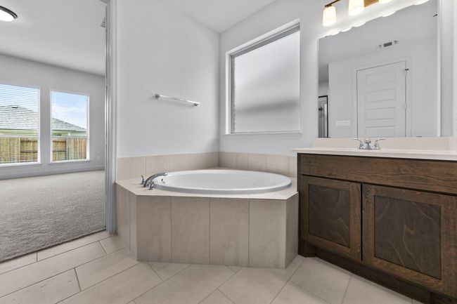 Full bathroom featuring vanity, a bath, and tile patterned flooring | Image 14