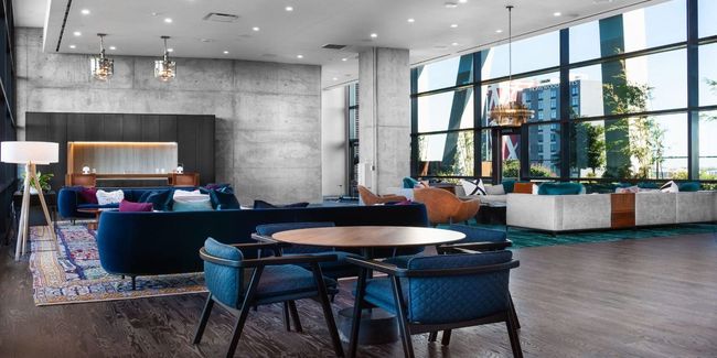 Common area with a towering ceiling, a wall of windows, and recessed lighting | Image 17