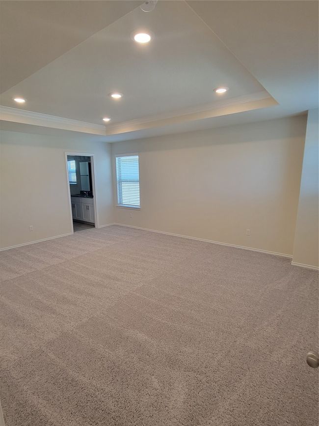 Unfurnished room with baseboards, carpet flooring, a tray ceiling, and ornamental molding | Image 19