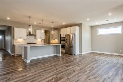 (*Photo of inventory home, actual homes colors and finishes will vary) This home flows seamlessly from room to room and offers a spacious open-plan layout! | Image 3