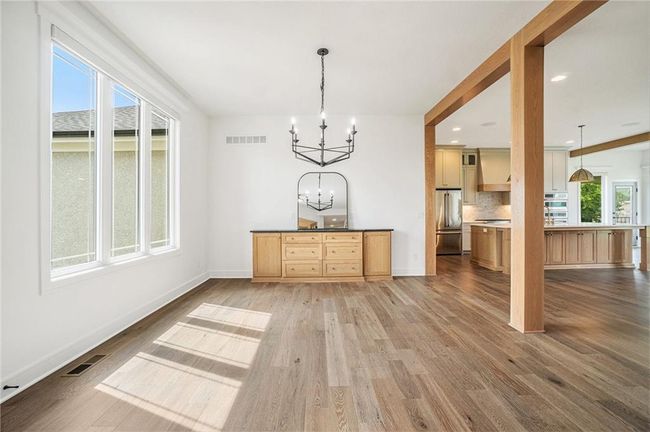 Unfurnished dining area featuring a chandelier, light wood-type flooring, and baseboards | Image 19