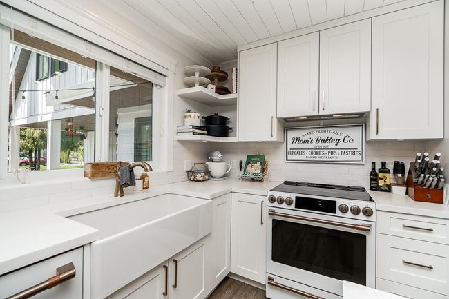 Kitchen featuring white range with electric stovetop, light countertops, and a sink | Image 7