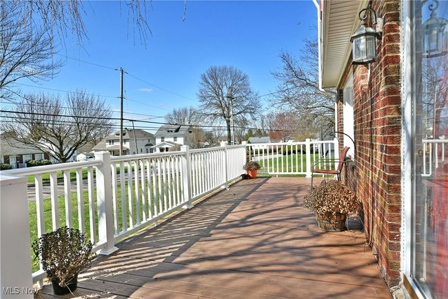 Wooden terrace with a residential view | Image 4