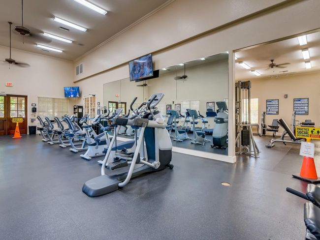 The gym is attached to the HOA office and boasts a weight room and plenty of cardio machines. Through the french doors are convenient restrooms for residents use. | Image 33