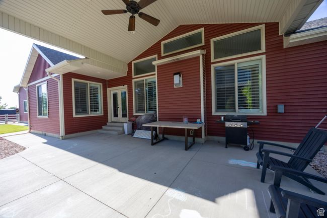 View of patio featuring entry steps, a ceiling fan, area for grilling, and french doors | Image 81