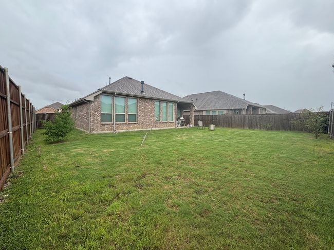 Rear view of property with a fenced backyard and brick siding | Image 15
