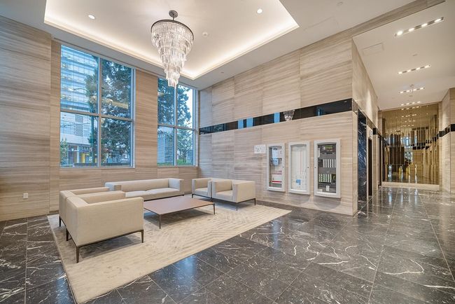 Community lobby with a towering ceiling, tile walls, and recessed lighting | Image 23