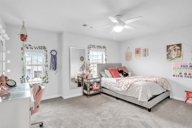 Carpeted bedroom with ceiling fan | Image 26