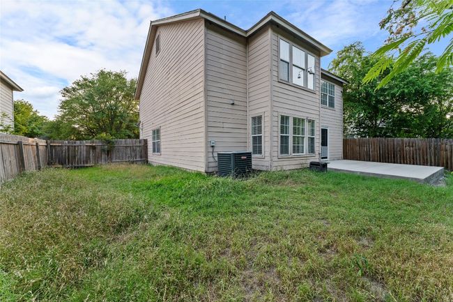 Rear view of property featuring a patio area and central AC unit | Image 34