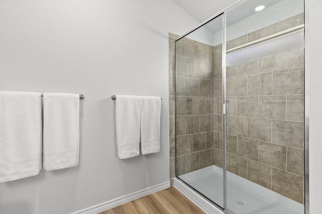Bathroom featuring wood finished floors and tiled shower | Image 26