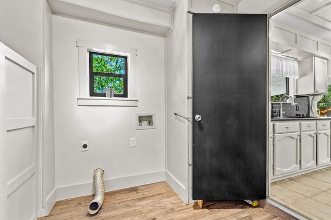 The laundry room offers practical space for both washing and drying, with room for additional storage or organization. | Image 25