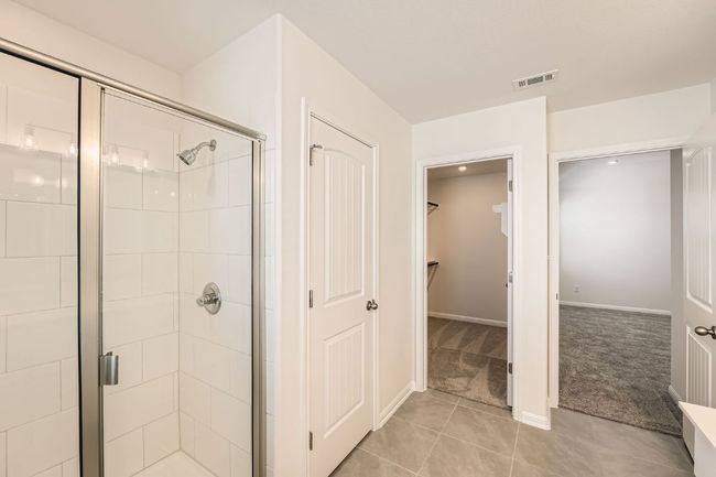 Full bath with tile patterned flooring, visible vents, a shower stall, and a spacious closet | Image 18