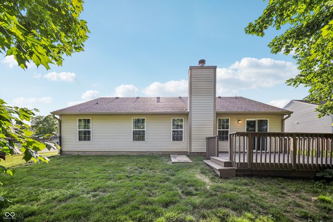 back of house with a yard, a wooden deck, and a chimney | Image 29
