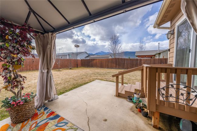 View of patio with a fenced backyard | Image 29