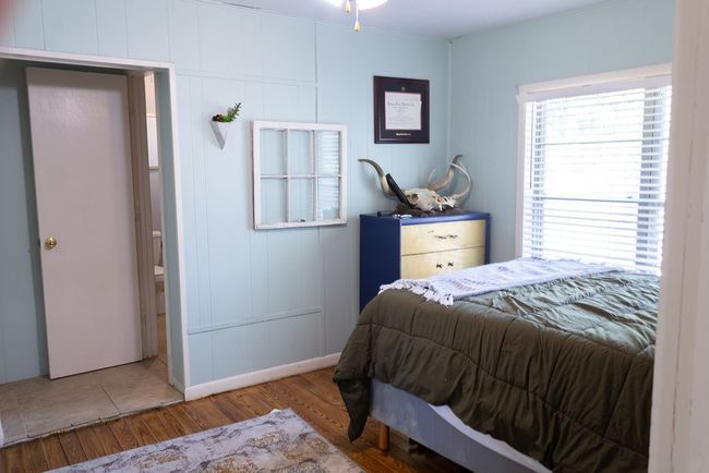 Bedroom featuring wood finished floors and a decorative wall | Image 10