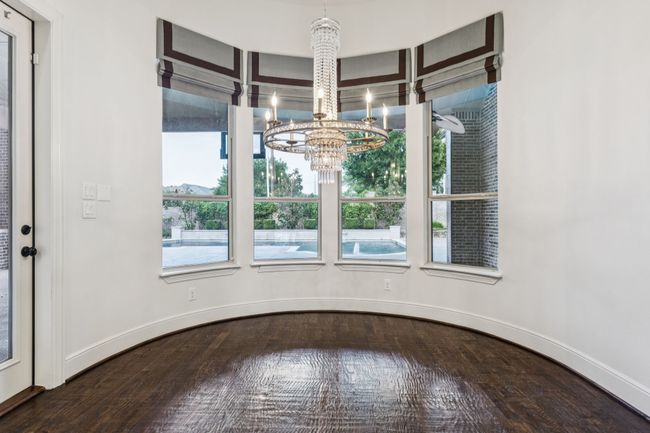 Unfurnished spacious breakfast nook with a chandelier, beautiful natural light, and baseboards | Image 7