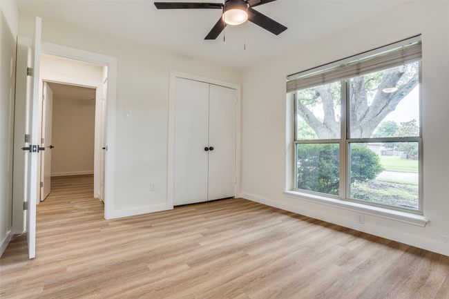 Unfurnished bedroom featuring light wood-style flooring, baseboards, a closet, and a ceiling fan | Image 15