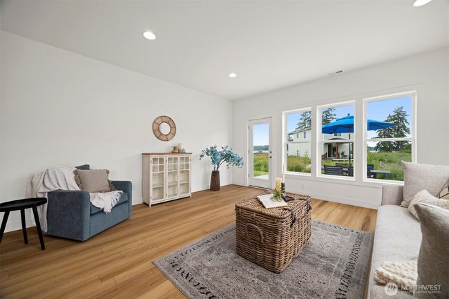The living room looks out to the saltwater views and opens to the patio. | Image 4