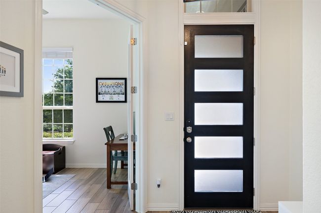 Contemporary front entry with sleek door design and immediate access to the home office for everyday ease. | Image 5