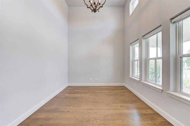 Large study with soaring ceilings and a wall of windows. | Image 25
