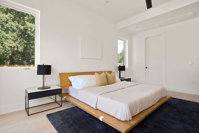 Bedroom featuring wood finished floors and baseboards | Image 11
