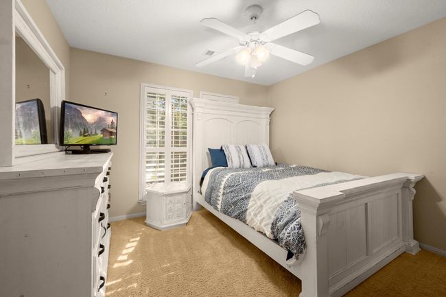 Bedroom 3 - Carpet, shutters, ceiling fan, neutral paint and a walk-in closet. Jack-n-Jill Bath #2 is accessible to this bedroom. | Image 28