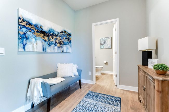 The home's entrance off the garage leads to this mudroom space, which (like the rest of the main level) is wide open and features both a large coat closet and powder room bath! Photo of model home, color and options will vary. | Image 19