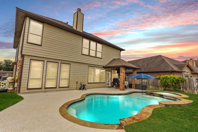 This backyard features solid board fencing providing more privacy. | Image 20