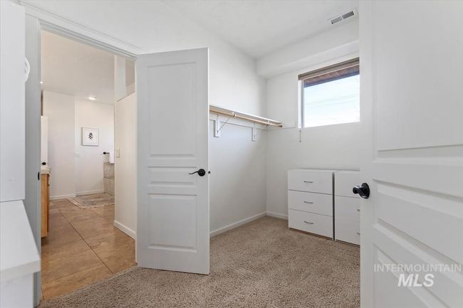 Spacious closet featuring light carpet and light tile patterned flooring | Image 36