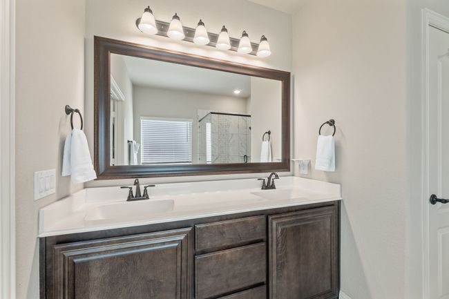 Full bath featuring a shower stall and double vanity | Image 18