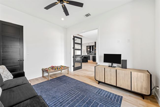 Living room with baseboards, visible vents, ceiling fan, and light wood-type flooring | Image 21